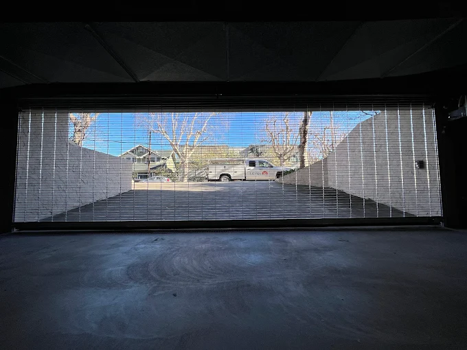 Level 10 service truck viewed through an open commercial security grille