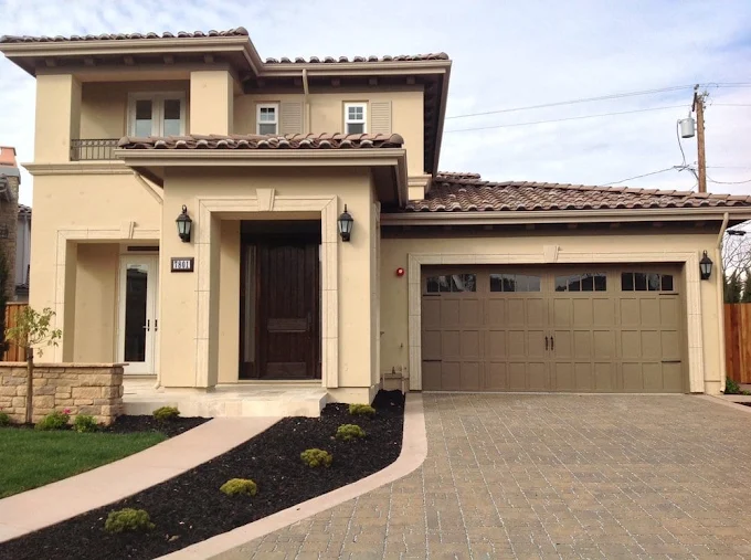 Two-story home with dark bronze carriage-style garage door