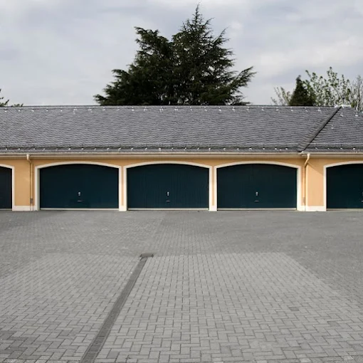 Row of matching garage doors on a multi-family property