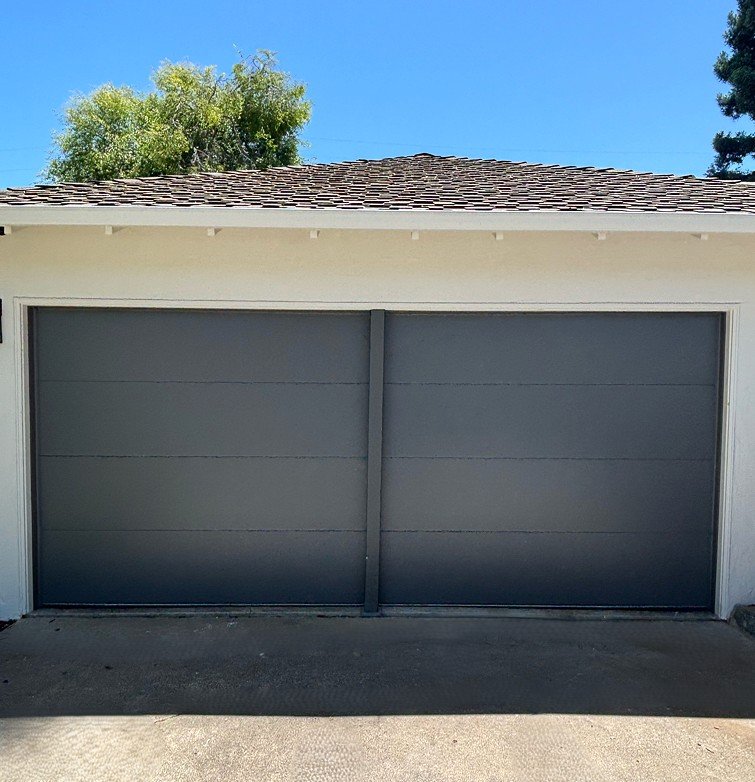 Dark gray modern flush-panel garage door installation